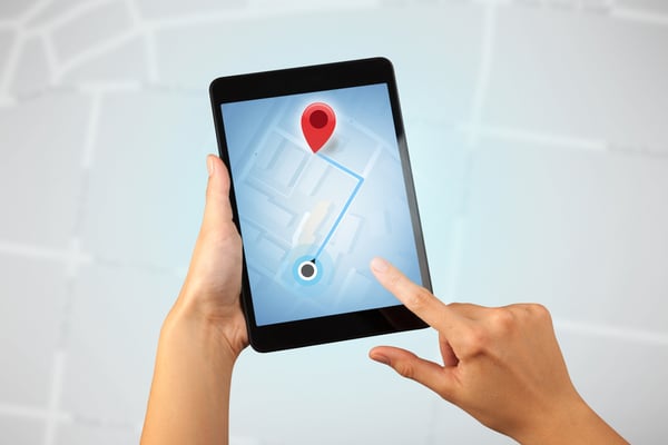 Female fingers touching tablet with map