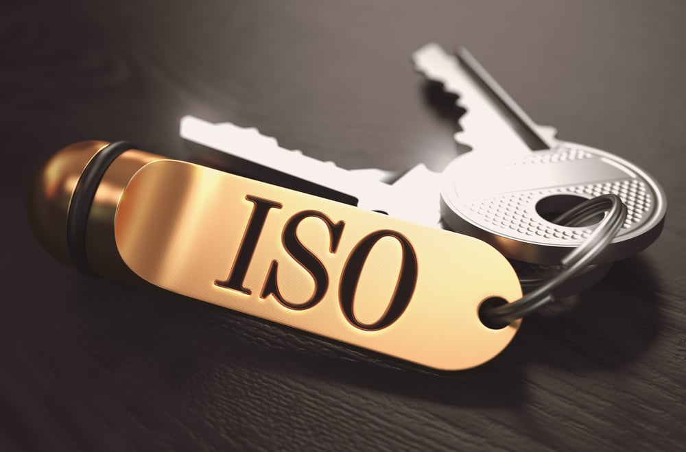 ISO - International Organization for Standardization - Concept. Keys with Golden Keyring on Black Wooden Table. Closeup View, Selective Focus, 3D Render. Toned Image.