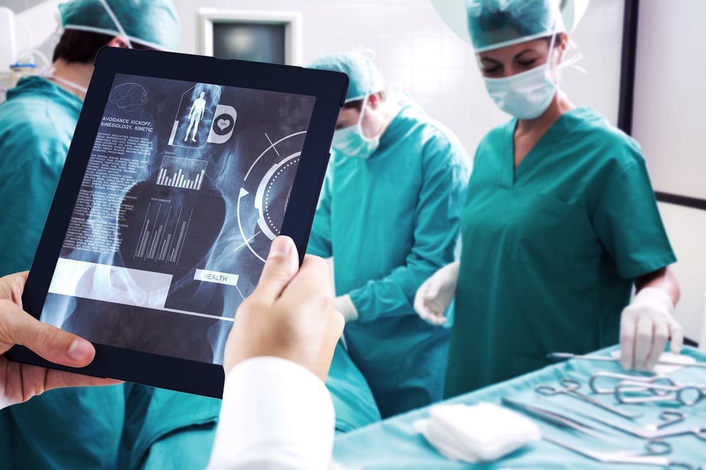 Man using tablet pc against medical interface on xray